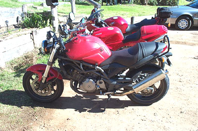 Classic motorcycle with some other crap in behind